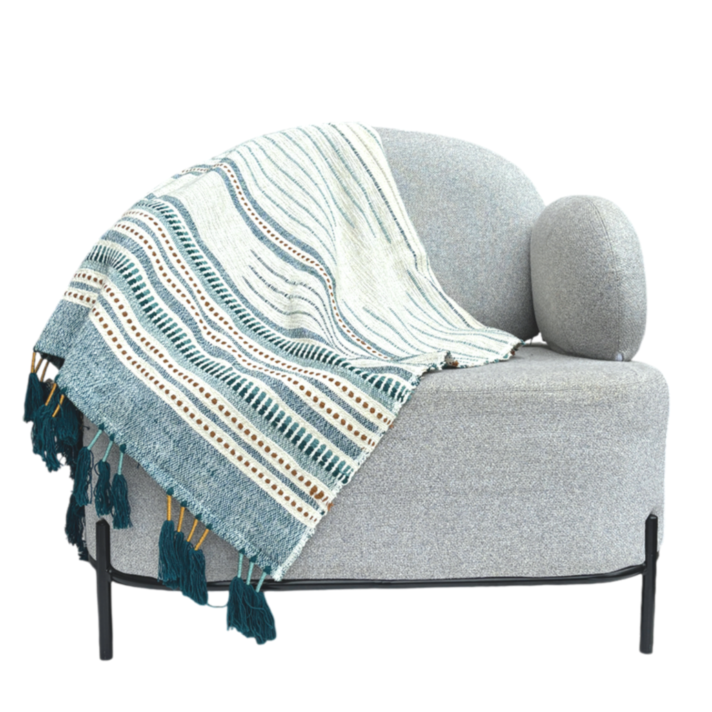 White throw with blue stripes and dots