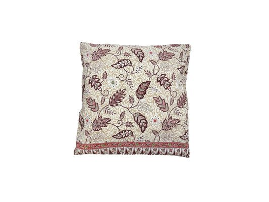 White cushion with maroon flowers